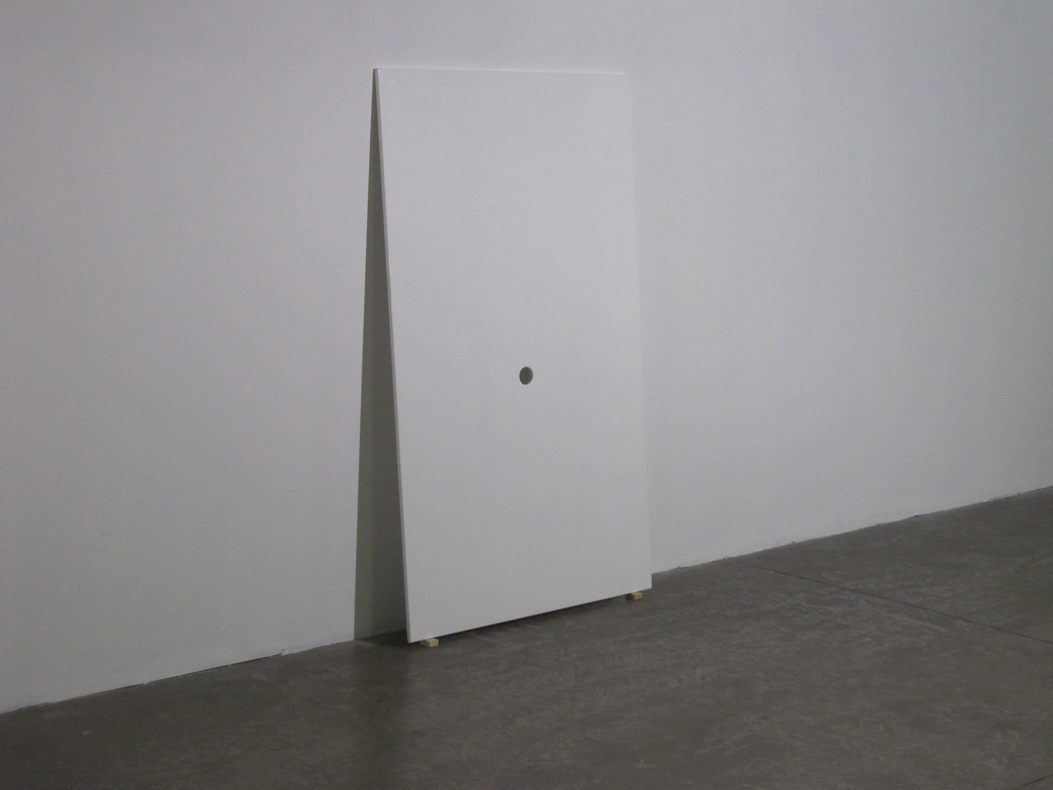 Glory Hole, 2012. MDF painted in white, hole. Installation view, Prometeogallery di Ida Pisani.